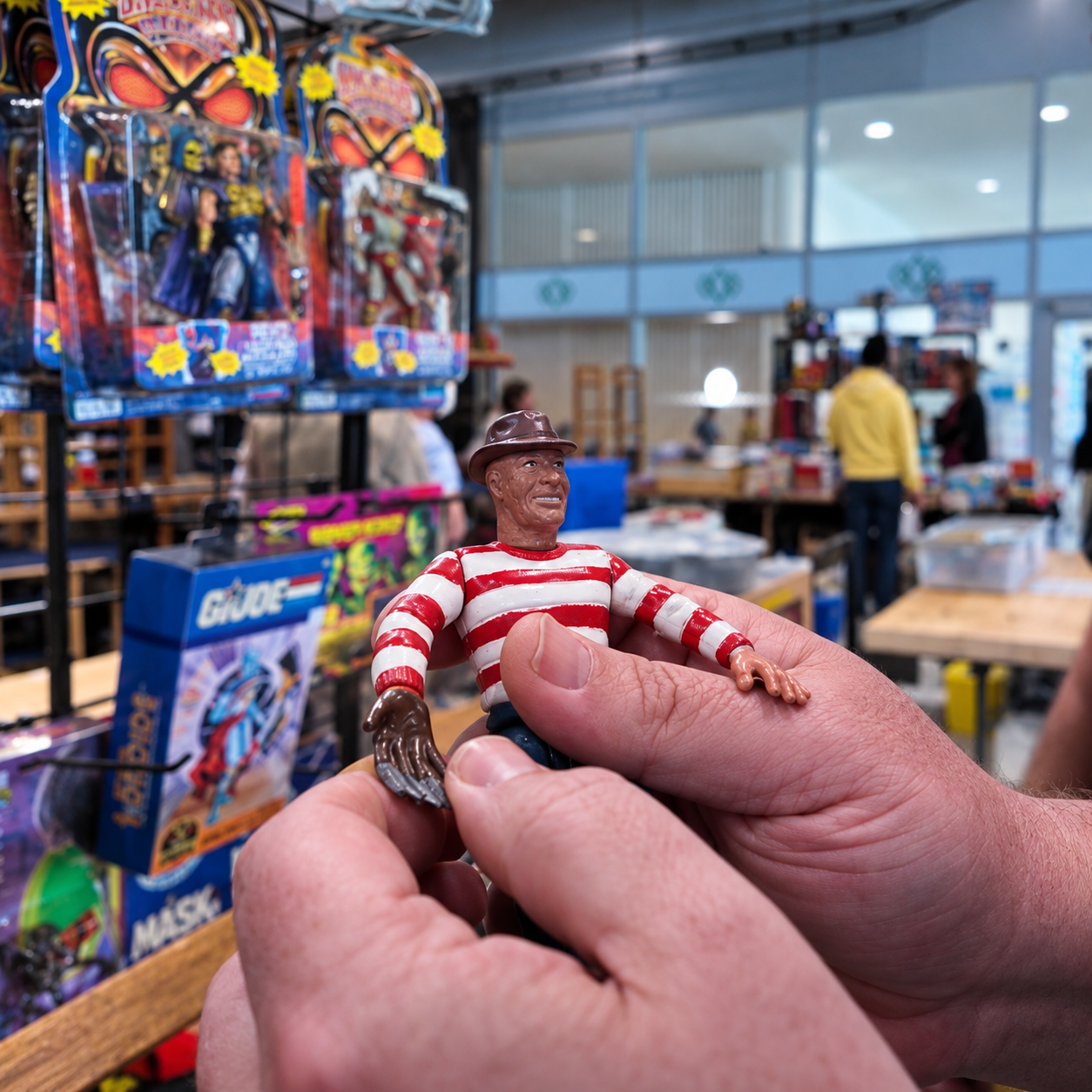 Vintage toy figure being examined at a toy fair